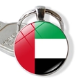 Detail of UAE flag glass dome keychain with silver metal ring and glossy round pendant - UAE