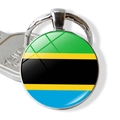 Close-up of Tanzania flag keychain with a glass dome and silver metal ring and key - Tanzania