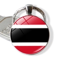 Close-up of glass dome keychain with Trinidad and Tobago flag design on metal base - Trinidad and Tobago