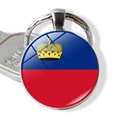 Close-up of Liechtenstein flag keychain with clear glass dome and silver metal ring - Liechtenstein