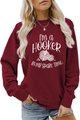 Close-up of the burgundy sweatshirt featuring a white crochet hook and yarn print design - S / Burgundy