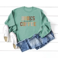 Flat lay of mint green sweatshirt with Books and Coffee print on white wood background - S / Light Green