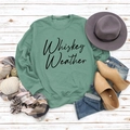 Flat lay of sage green sweatshirt with Whiskey Weather text and autumn accessories - Light Green Sweatshirt (Black Font)