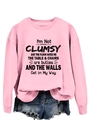 Detail of pink crewneck sweatshirt with humorous black text print and cotton fabric texture - Pink