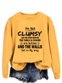 Detail of ginger yellow crewneck sweatshirt with black humorous letter print and ribbed cuffs - Yellow