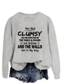 Detail of grey crewneck sweatshirt featuring humor text and ribbed cuffs texture - Gray