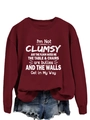 Detail view of burgundy sweatshirt with white text print and ribbed cotton cuffs - Burgundy