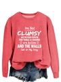 Detail of red crewneck sweatshirt with white text print and frayed denim shorts - Red (White Font)