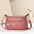 Pink lychee grain leather crossbody bag with three zipper layers and gold kangaroo logo - Pink