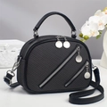 Elegant black textured handbag with diagonal zippers and adjustable shoulder strap - Black