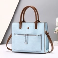 Light blue tote bag with geometric texture, brown handles and metal chain detail - Blue