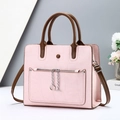 Pink textured leather tote bag with dark brown handles and silver chain detail - Pink