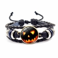 Detail of Halloween braided leather bracelet featuring a glowing Jack-o-lantern glass charm - Jack-o'-lantern Face Style (JY002586-9)