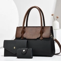 Dettaglio del set borsa tote in pelle marrone e nera con pochette e porta carte abbinati - Nero