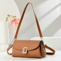 Detail of brown woven texture shoulder bag with silver buckle on minimalist display - Earthy Yellow