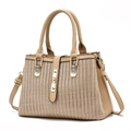 Detail of khaki woven texture and lychee grain leather on a stylish trapezoid handbag - Light Khaki