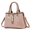 Close-up of a minimalist leather tote bag showing side view and textured grain fabric - Pink