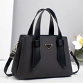 Detail of grey fabric tote with leather trim and golden triangular metal emblem - Black