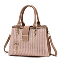 Detail of woven texture pink handbag with brown leather accents and gold chain link - Pink