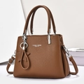 Brown litchi texture tote bag with silver hardware and star pendant for daily commute - Earthy Yellow
