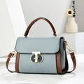 Bolso de mano de cuero azul claro y marrón con cierre giratorio en forma de T dorado - Azul