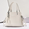 Detail of cream lychee texture leather handbag with silver logo and star pendant - Off White