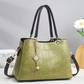 Detail of green croc-embossed tote bag with gold hardware and pearl tassel pendant - Green