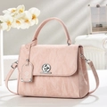 Elegant textured dusty pink handbag with silver ring twist lock and top handle - Pink
