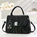 Elegant black pleated leather handbag with silver twist lock and floral background - Black