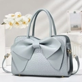 Light blue bow handbag with crocodile pattern texture and golden hardware details - Blue