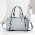 Detail of light blue textured leather handbag with star charm and adjustable strap - Blue