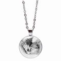 Detail of silver wolf glass pendant showing the realistic black and white twin wolves pattern - Silver