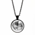 Detailed close-up of a round black wolf pendant necklace with a glass dome cover - Black