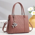 Detail of dusty pink quilted leather tote with elegant silver balloon dog charm - Dusty Pink