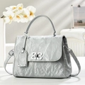 Detail of silver pleated leather bag with butterfly metal clasp and adjustable strap - Blue