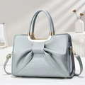 Elegant blue-grey tote bag with bow accent, woven texture, and gold handles for women - Blue