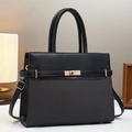 Classic black top-handle handbag featuring quilted patchwork design and golden metal lock - Black