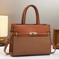 Vintage caramel crossbody bag with brown woven texture and polished gold buckle hardware - Earthy Yellow