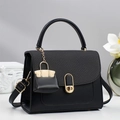 Chic black square handbag with woven flap and golden oval lock on a neutral background - Black