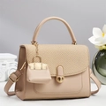 Close-up of beige leather handbag with woven texture flap and golden round metal clasp - Khaki