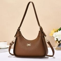 Close-up of brown pebbled leather hobo bag with a gold bow buckle and fashion engraving - Earthy Yellow