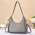 Gray textured leather underarm bag with gold bow clasp and elegant floral background - Gray