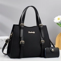 Detail of black twill leather handbag set with gold hardware and matching card holder - Black