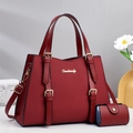 Detail of burgundy tote and coin purse set with textured surface and gold Danbaoly logo - Red