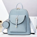 Detail of light blue backpack with gold metal buckles and a matching detachable round coin purse - Blue