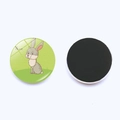 Detail showing the cartoon hare design and magnetic back of the 25mm glass fridge magnet - Hare Style (JY003526-10)