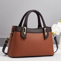 Detail of lychee textured leather tote with contrasting brown handles and gold hardware - Earthy Yellow