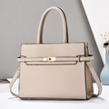 Detail of lychee pattern leather handbag featuring a light gold twist lock and strap - Khaki