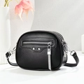 Minimalist black pebble leather crossbody bag with silver fringe and metal studs - Black