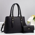 Detail of black lychee grain leather tote bag set with gold studs and round ring handles - Black